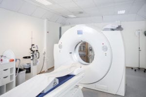 White MRI machine in empty room of hospital